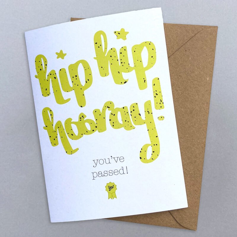 A hand calligraphy greeting card with hip hip hooray you've passed in green on a white background