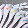 Close up view of custom name hangers in rainbow colourway