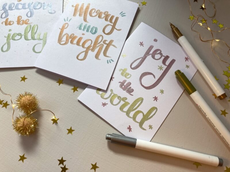 Close up of finished Christmas cards showing the metallic finish of the brush pens