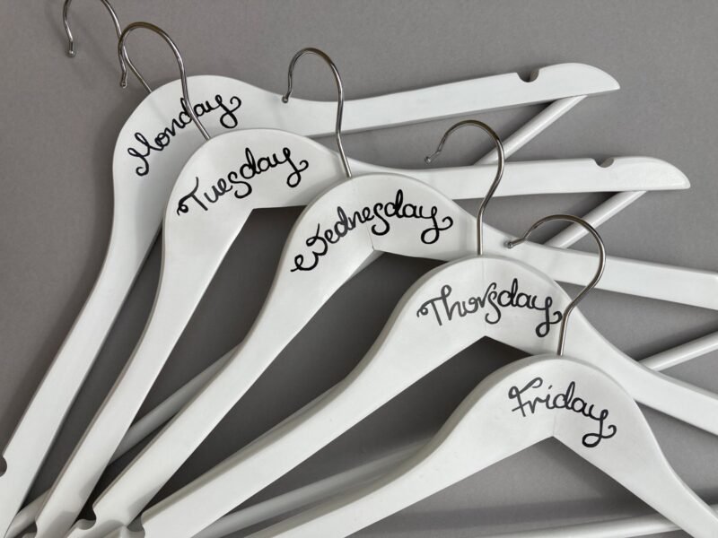 Close up view of black writing Monday to Friday hangers