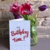 It's Birthday Time 5x7 card next to a vase of tulips